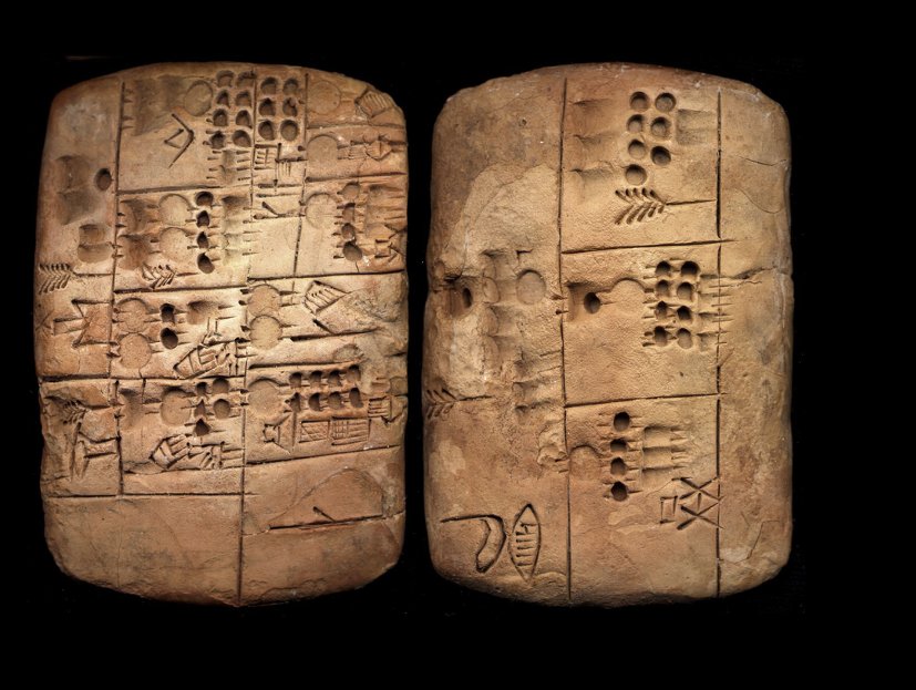 Two sides of a clay accounting tablet pressed with rows of round marks and signs.